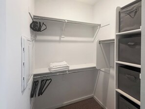 A walk-in closet with shelves, drawers, and hanging rods. - Modern 3BR Casa Grande Retreat | Pool Access + I-10 (Casa Grande)