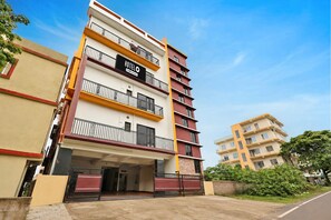A multi-story hotel with balconies, a visible entrance, and a clear sky. - Hotel Infocity Square Bhubaneswar (Bhubaneshwar)
