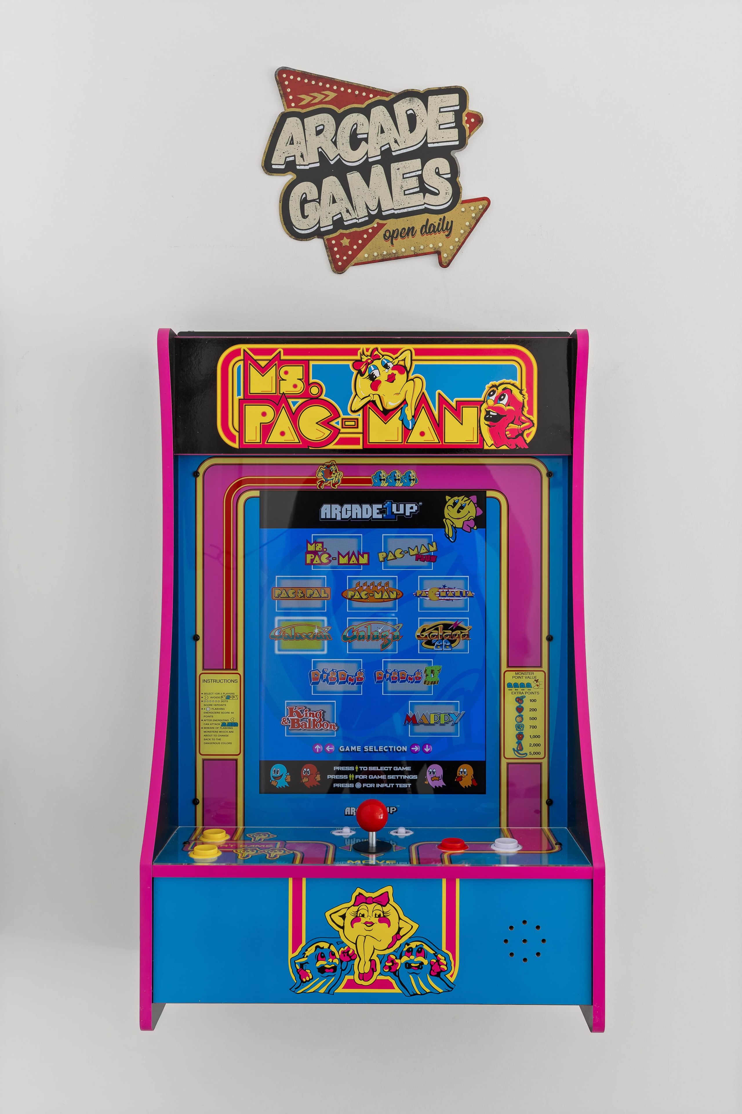 A vintage arcade game machine with a colorful display and a selection of games.