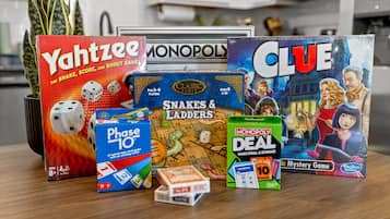 A variety of board games including Yahtzee, Monopoly, Clue, Phase 10, and Snakes & Ladders.