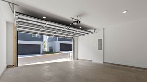 A spacious garage with a metal roof and a clear view of the street outside.