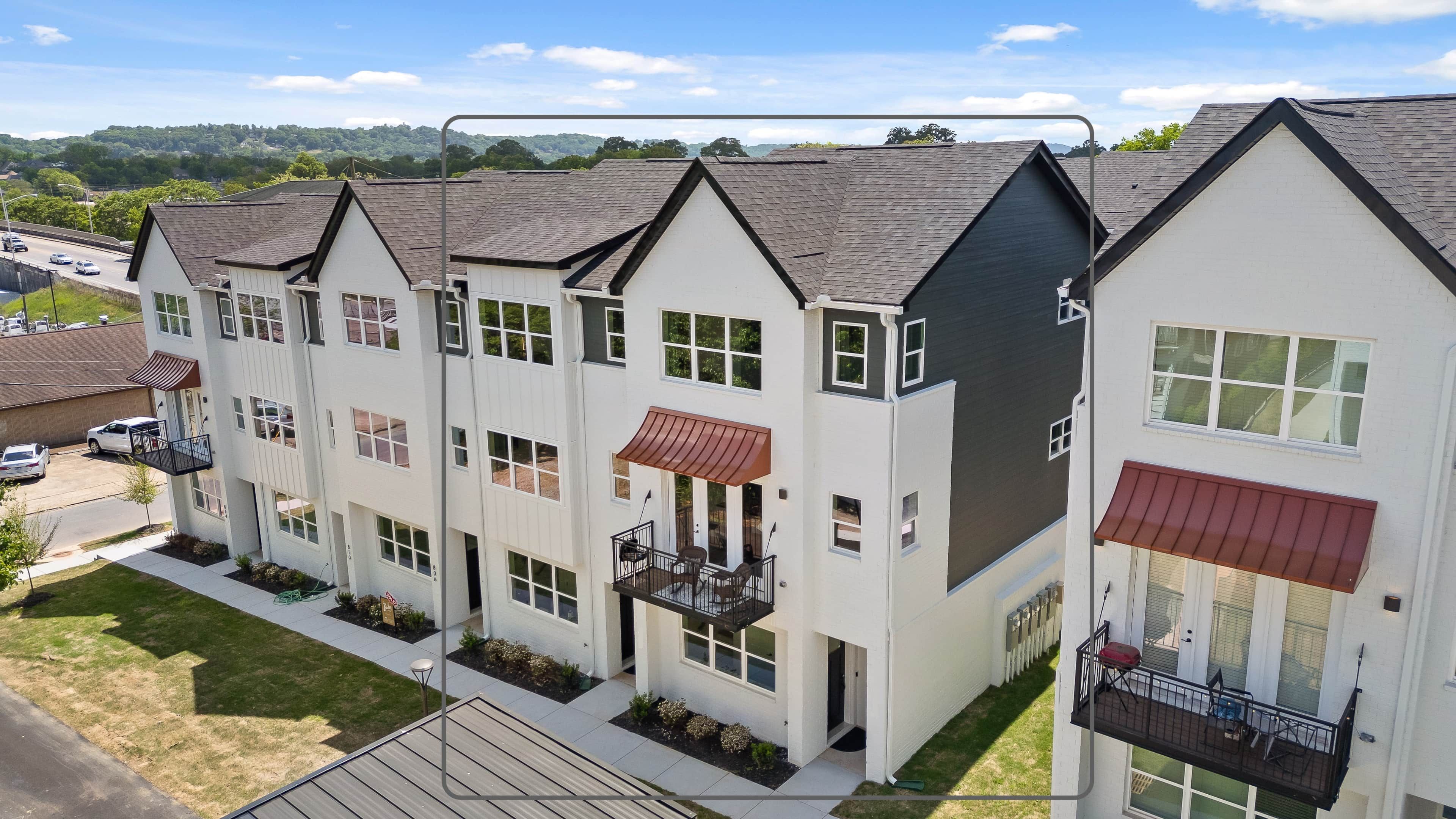 A multi-story residential building with a flat roof, multiple windows, and balconies.