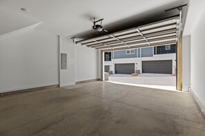 A garage with a concrete floor and a metal roof structure.
