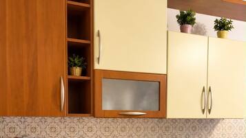 A kitchen with wooden cabinets, a built-in microwave, a coffee machine, and a sink.