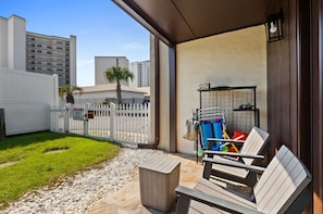 A patio area with a white fence, a small garden, and a seating area with a table and chairs. - Two Bed, Two Bath Townhouse | Sleeps 8 | Community Pool | No Additional Fees (Panama City)
