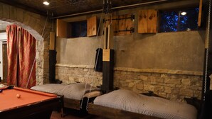 A room with a pool table, two beds, stone walls, and a wooden ceiling. - Family friendly castle, 17th century archaic chateau, providing all amenities. (Franklin)