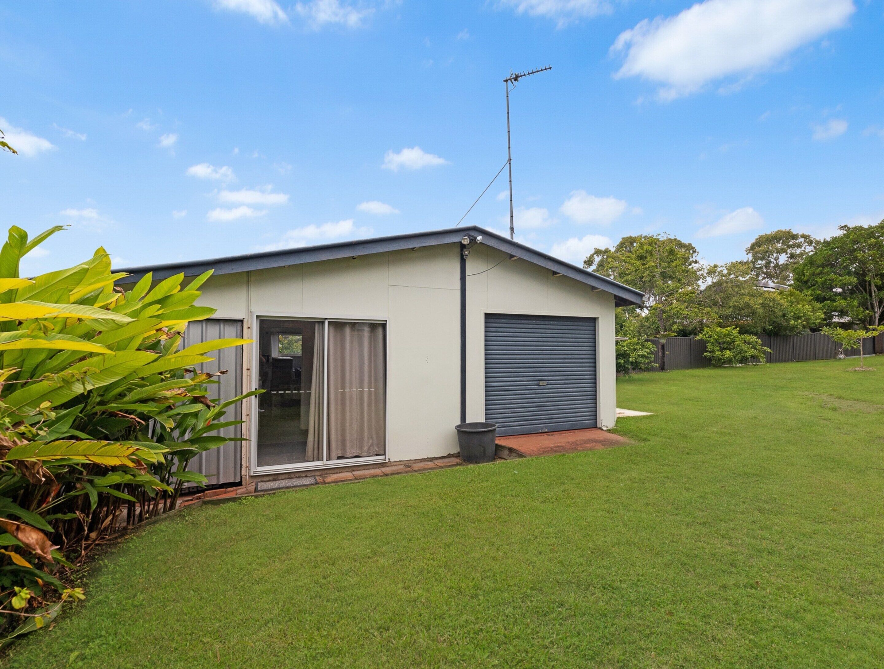 A single-story house with a garage, a sliding glass door, and a small front yard.
