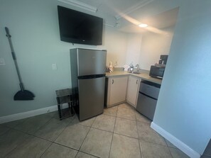 A compact kitchen with a refrigerator, microwave, and a sink. - Pelican Pointe 425:Walk to Beach~Pool~Free Parking (Clearwater Beach)