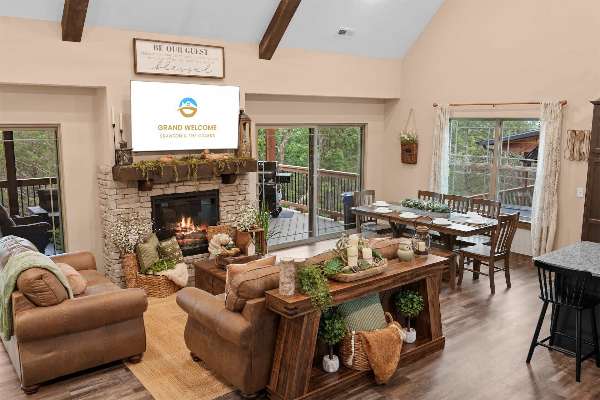A cozy living room with a fireplace, comfortable seating, and a dining area.