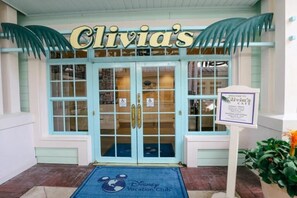 A building entrance with a sign reading 'Clivia's' above the doors. - Orlando | Laid-Back Island Escape | Pool + Golf (Lake Buena Vista)
