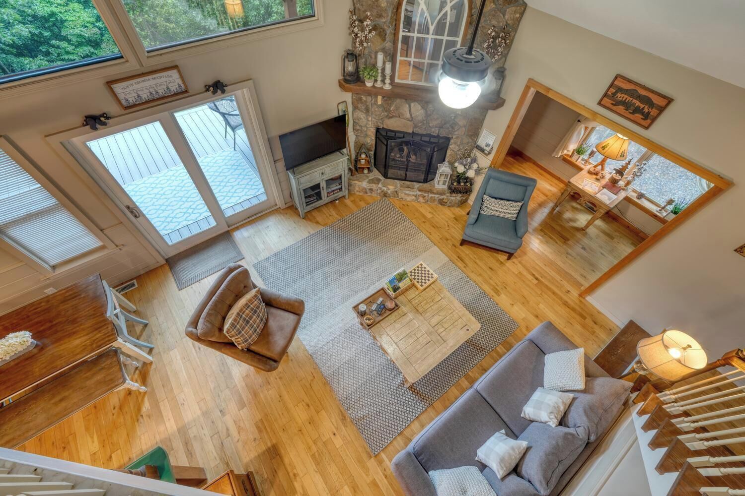 A spacious living area with a fireplace, a television, and a dining table.