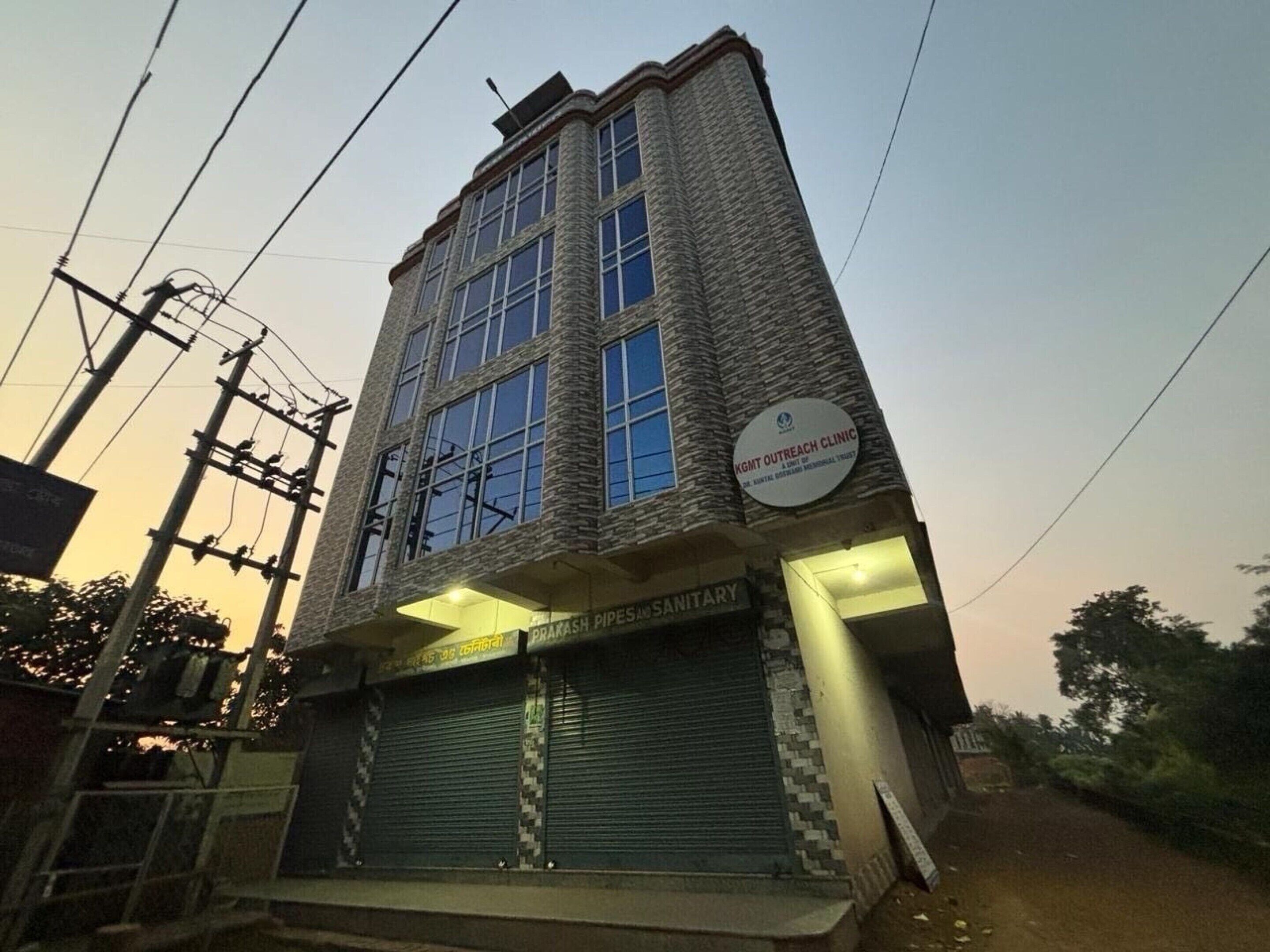 Un bâtiment sur lequel on peut voir une enseigne indiquant « Clinique mobile de KGMT » et une autre indiquant des installations sanitaires.
