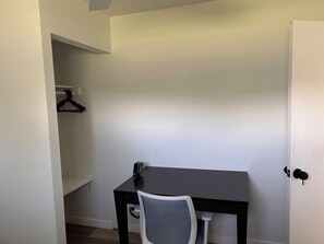A room with a desk, chair, and a white door. - Delightful 3-bedroom house with AC in Fort Myers (Fort Myers)