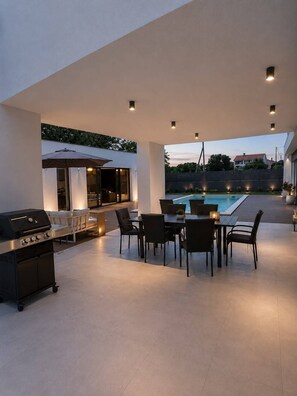 An outdoor patio area with a pool, a grill, and seating. - Luxury Villa MariQ  Heated Pool  Near Rovinj (Žminj)