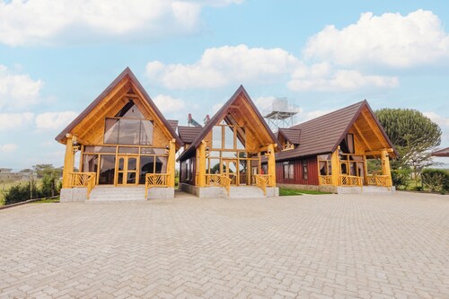 Rustic A-frame cabins blending natural wood,glass and serene outdoor living