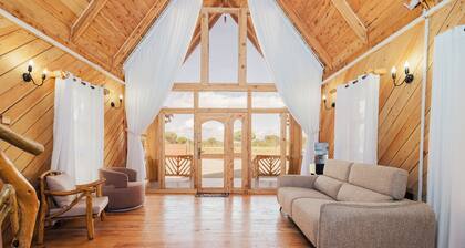 Rustic A-frame cabins blending natural wood,glass and serene outdoor living