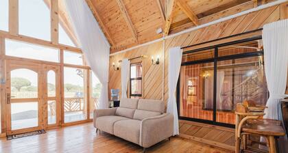 Rustic A-frame cabins blending natural wood,glass and serene outdoor living