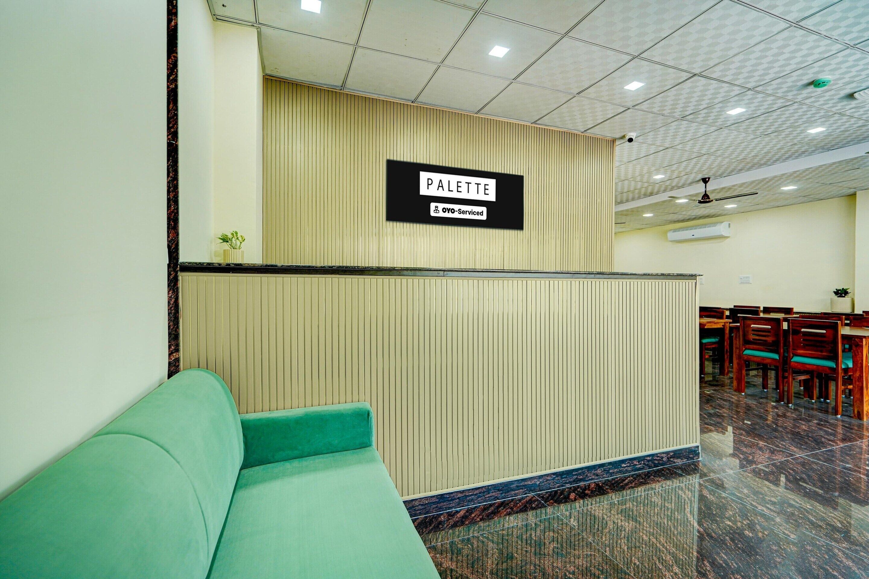 A reception area with a sign reading 'PALETTE' and a green sofa.