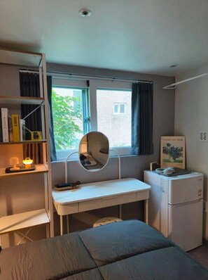 A bedroom with a bed, a desk with a mirror, a small refrigerator, and a window with curtains. - NONHYEON Station GANGNAM - Double Bed Studio - Private Apartment #Clinic #Travel (Seoul)