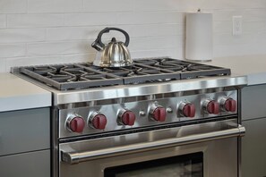 A stainless steel stove with four burners and a kettle on top. - 1491 April Mountain Drive (Park City)