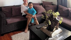 A living room with a sofa, a coffee table with a plant, and a chandelier. - Room-luxurious Villa Rental in Umingan w (Umingan)