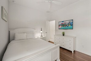 A bedroom with a bed, a nightstand, a dresser, a ceiling fan, and a TV on the wall. - Sleeps 10*Private Pool*Games Room*Resort Amenities (Davenport)