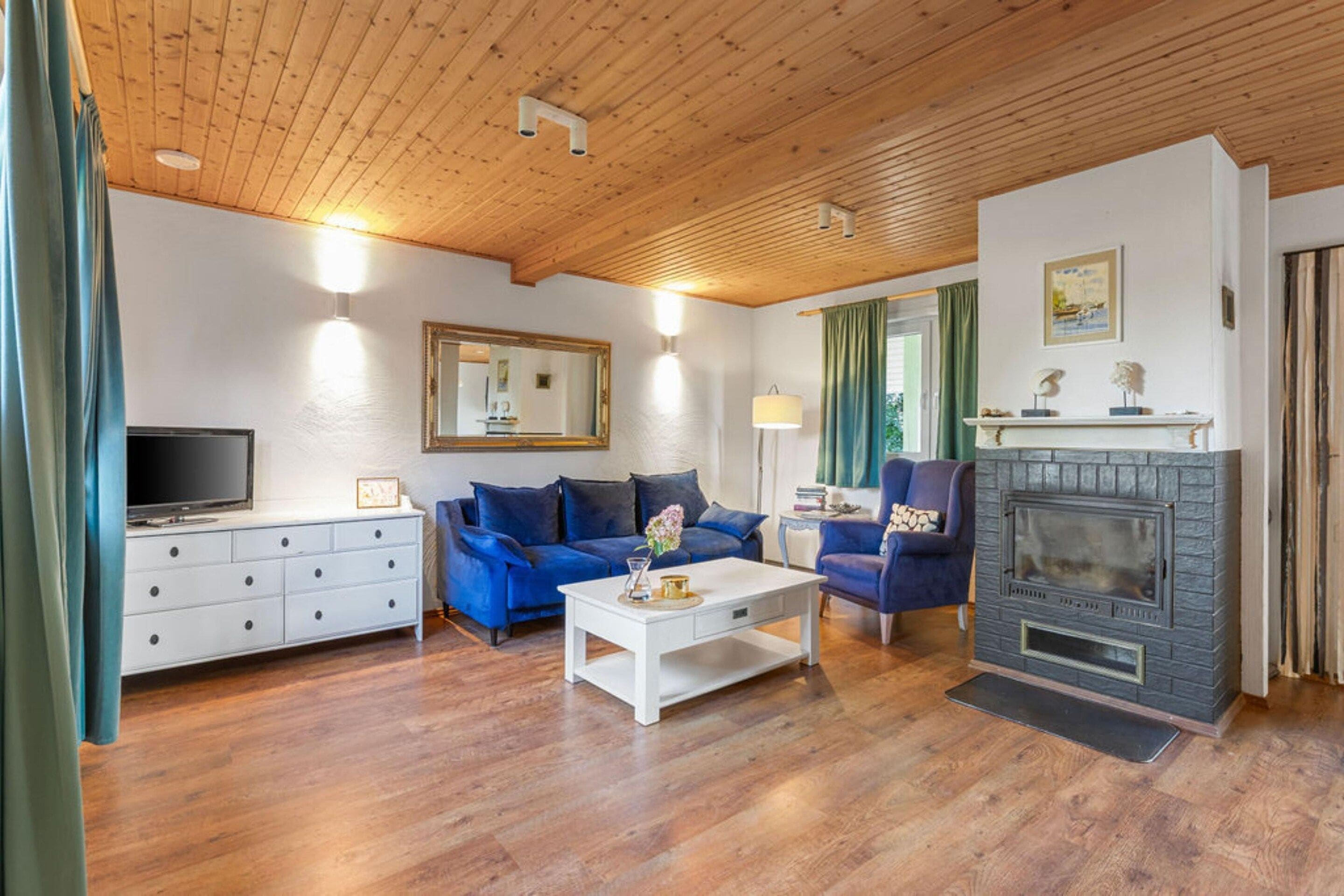 A living room with a fireplace, a sofa, a coffee table, and a television.