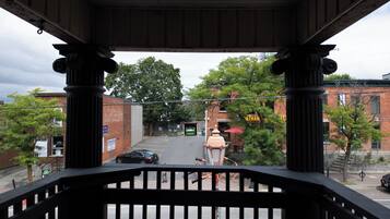 A covered outdoor area with a view of a street, including a building with a sign that reads 'Vietnam.'