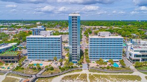 A high-rise hotel with multiple floors, a rooftop pool, and a beach area with a walkway. - Oceanfront Serenity at Yachtsman S804 (Myrtle Beach)