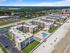 A multi-story hotel with a rooftop pool and a beachside location. - 🌊Top Floor 1BR Condo | Ocean + Pool Views | Sleeps 4 | Castle Reef 527🌊 (New Smyrna Beach)