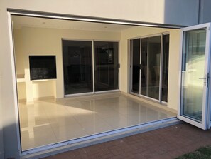 A modern building with a large glass door leading to an interior space.