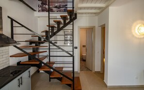Eine moderne Küche mit einer schwarzen Treppe und Holzstufen.