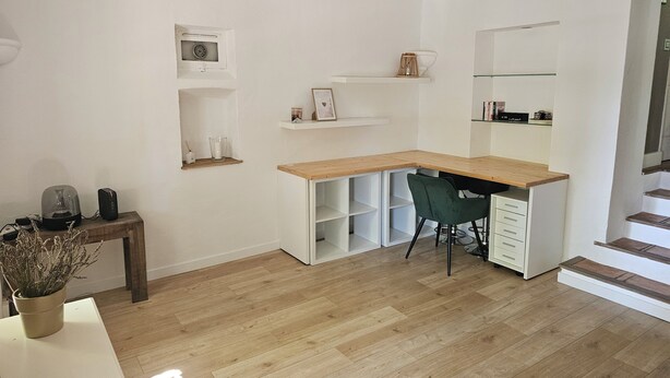 A modern, minimalistic room with a wooden desk, a green chair, and built-in shelving. - A Provençal stone farmhouse dating from 1870, with a terrace and a pool. (Mougins)