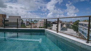 A rooftop pool with a clear view of the surrounding buildings and sky. - Luxury studio apartment 3 minutes from the natural pools (Ipojuca)