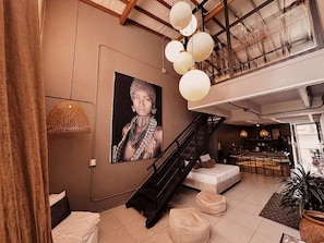 A modern interior with a staircase, a bar area, and a large framed artwork on the wall. - Luxury Provence Terrace (Medellín)