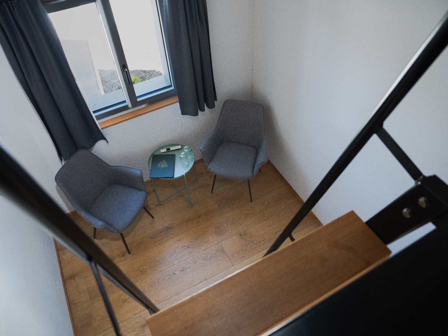 A room with two chairs, a small table, and a window with curtains.