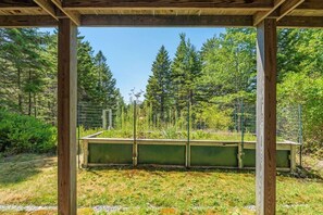 A wooden structure with a view of a forested area. - 5BR Home Quietside of MDI - Sleeps 23! [Headlands] (Tremont)
