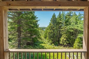 A wooden structure with a view of a dense forest. - 5BR Home Quietside of MDI - Sleeps 23! [Headlands] (Tremont)