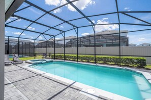 A swimming pool with a clear view of the sky through a metal roof structure. - Stunning Windsor Island 10BR (Davenport)