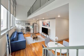 Eine moderne Wohnung mit Wohnzimmer, Küche und Essbereich.