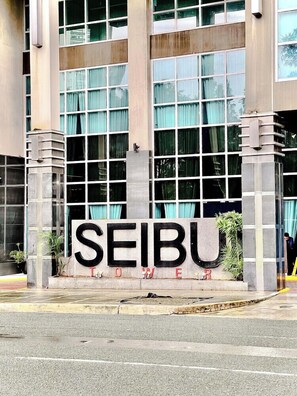 A building with a sign that reads 'SEIBU Tower.' - Relaxing Condo Stay in Seibu Tower (Taguig City)
