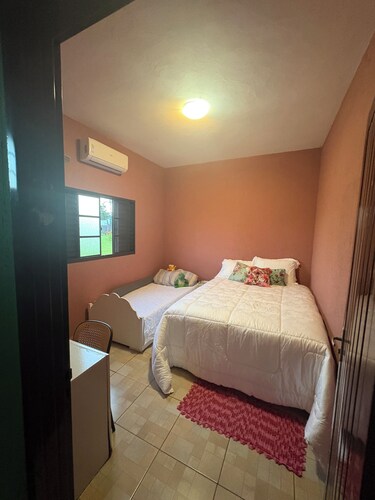 Rustic house with air conditioning and a box spring bed.