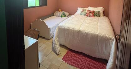 Rustic house with air conditioning and a box spring bed.