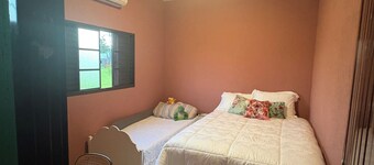Rustic house with air conditioning and a box spring bed.