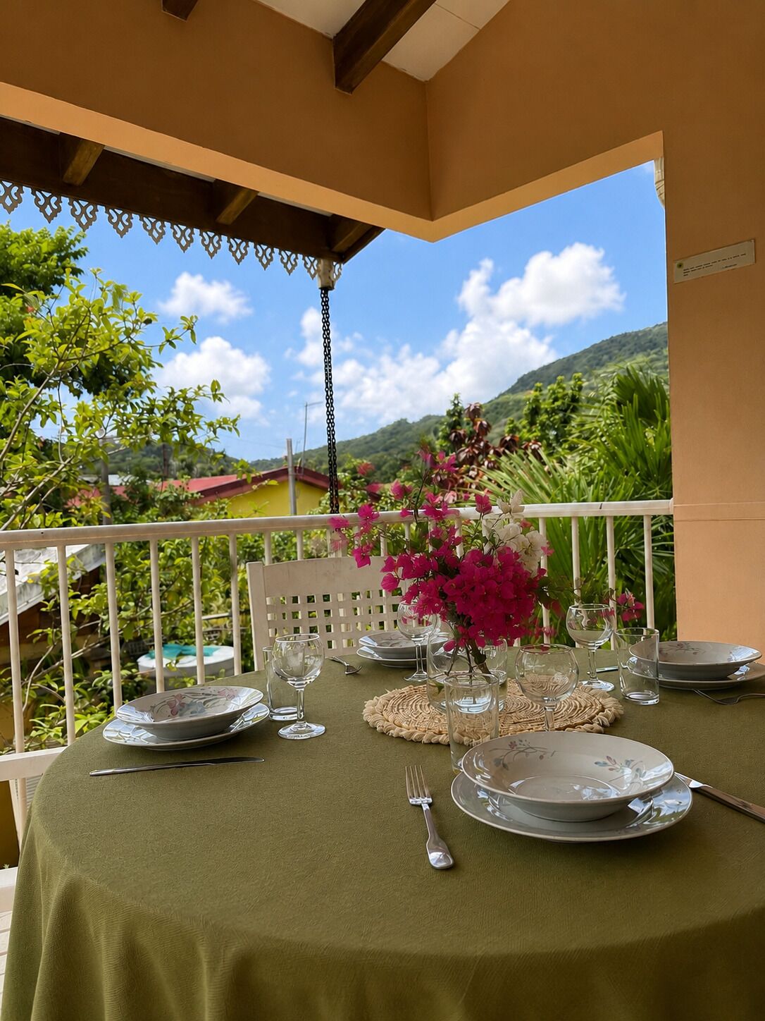 A table set for dining with a view of a mountainous landscape.