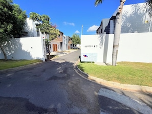 A residential street with a sign for 'Sun House' indicating a property for sale. - Private Pool Villa. 3BR Near Bávaro Beach. Sleeps 8 (Punta Cana)