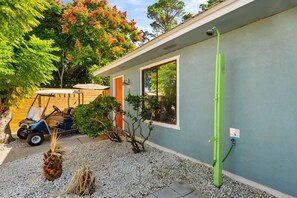 A house with a covered patio, a golf cart, and a green hose. - POOL/Golf Cart/Hot Tub/Playground/Grill/Arcades (Panama City)