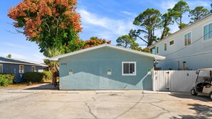 A single-story house with a garage, numbered 6202, surrounded by trees and other houses. - POOL/Golf Cart/Hot Tub/Playground/Grill/Arcades (Panama City)