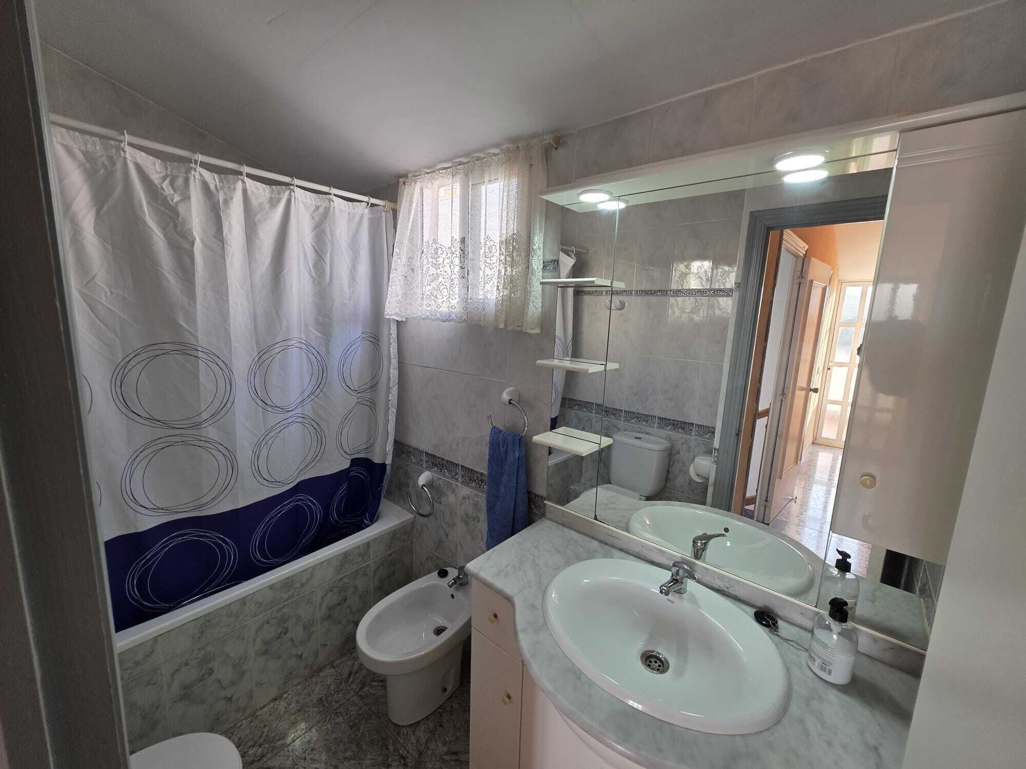 A bathroom with a shower, two sinks, a toilet, and a bathtub.