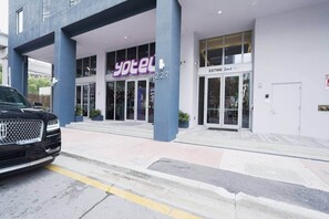 A hotel entrance with a modern design, including a prominent 'yotel' sign, a numbered address, and a visible entrance door. - NEW Lux Condo - High-Floor Views · Gym · Pool · (Miami)